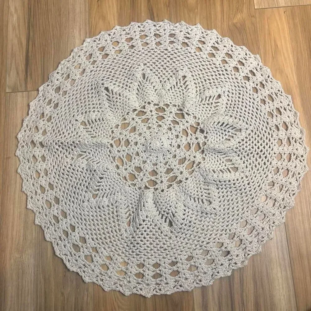 Cream crochet doily placemat with floral and geometric lace patterns